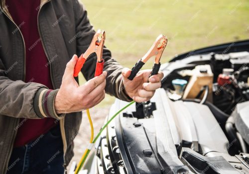 man-stands-front-car-holding-battery-jumper_438099-731.jpg
